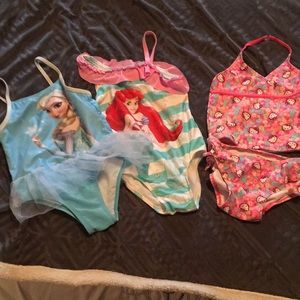 One two-piece and two one-piece suits